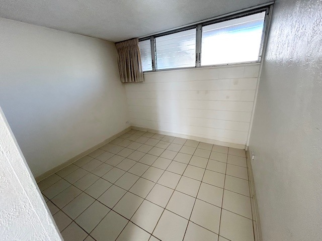 A room with white walls and a tiled floor.